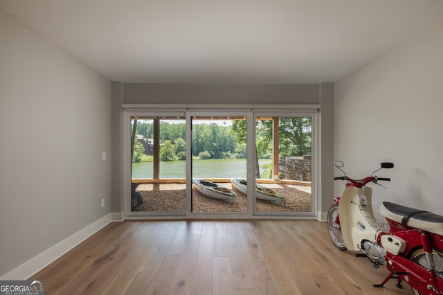 interior space featuring a water view and light hardwood / wood-style floors