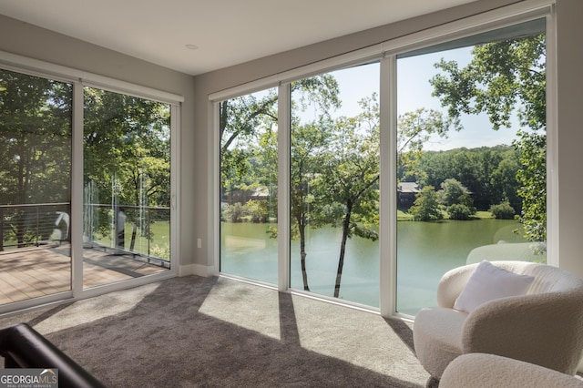 sunroom / solarium with a water view