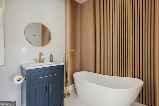 bathroom with vanity and a bath