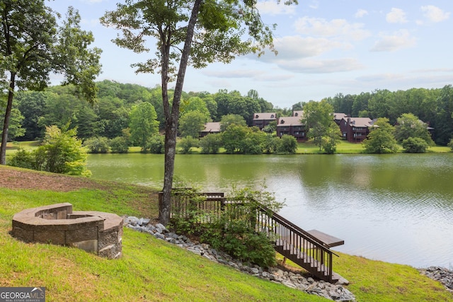 view of yard featuring a water view and a fire pit