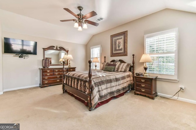 carpeted bedroom with ceiling fan, vaulted ceiling, and multiple windows