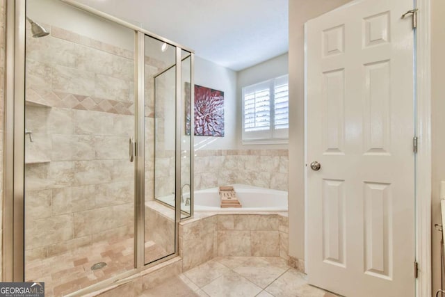 bathroom with tile patterned floors and separate shower and tub