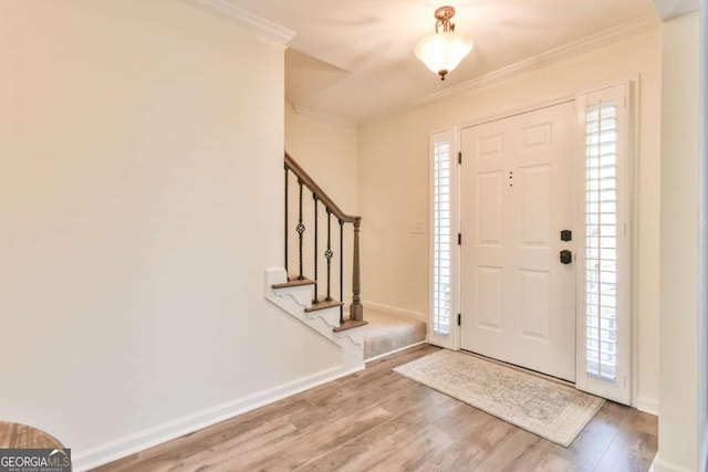 entryway with crown molding and wood-type flooring