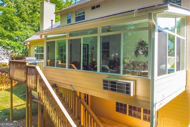 wooden deck with a sunroom