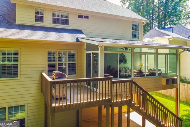 wooden deck featuring a sunroom