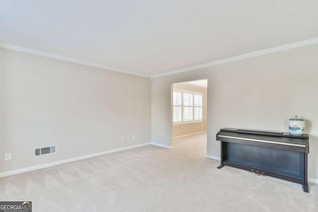 carpeted spare room featuring crown molding