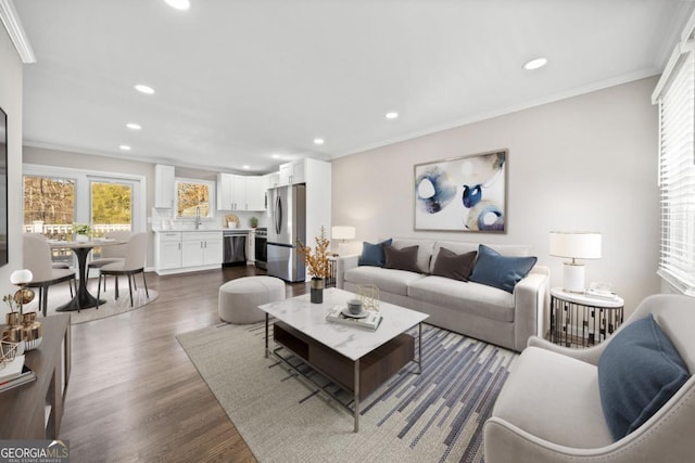 living room with dark wood-type flooring and ornamental molding