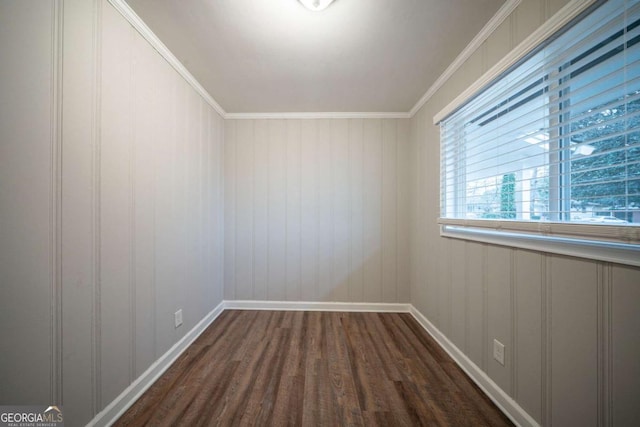 empty room featuring crown molding and dark hardwood / wood-style floors