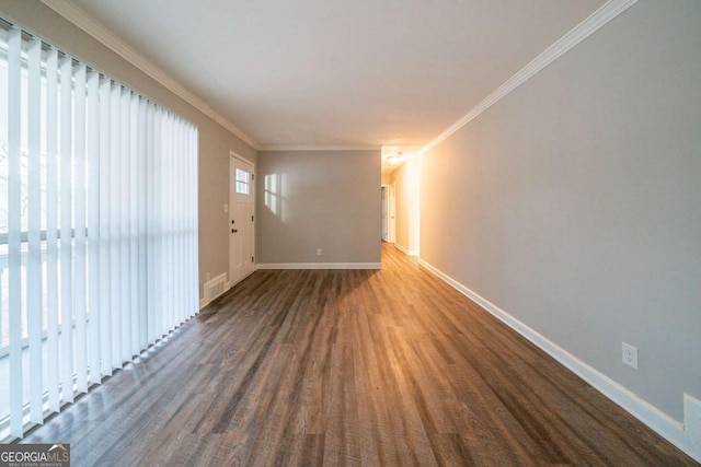 unfurnished room with crown molding and dark wood-type flooring