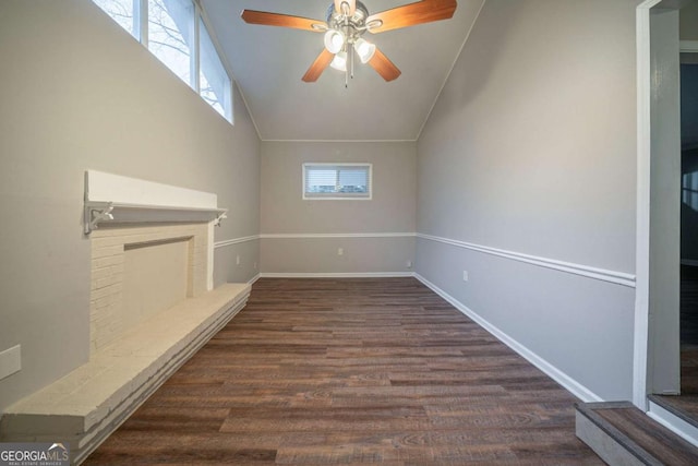 unfurnished living room featuring lofted ceiling, dark wood-type flooring, and ceiling fan