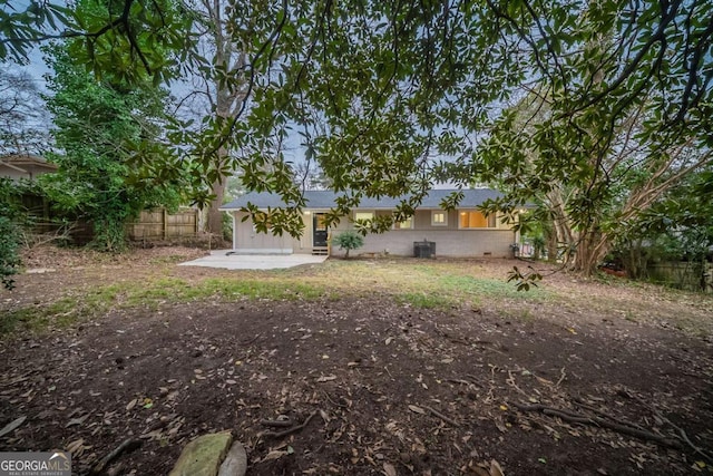 view of yard featuring a patio and central AC