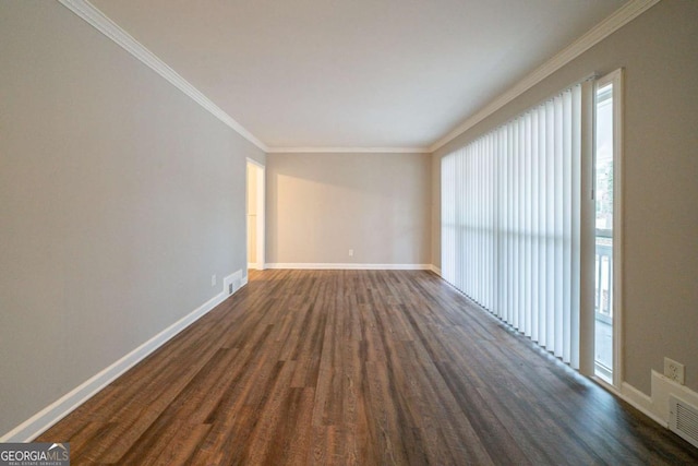 empty room featuring crown molding and dark wood-type flooring