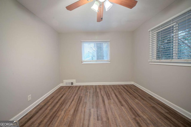 unfurnished room with dark wood-type flooring and ceiling fan