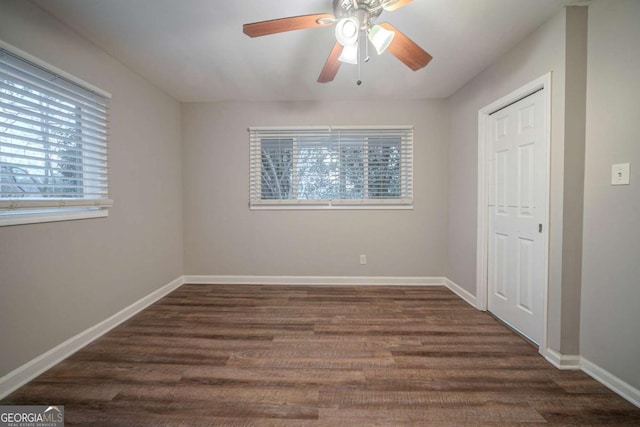 unfurnished bedroom featuring dark wood-type flooring, a closet, and ceiling fan