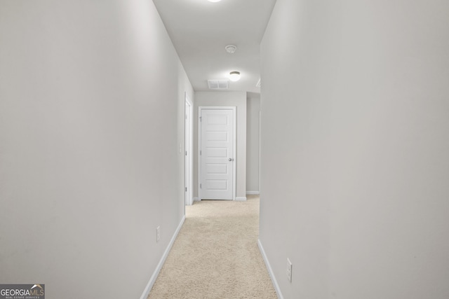 hall featuring light carpet