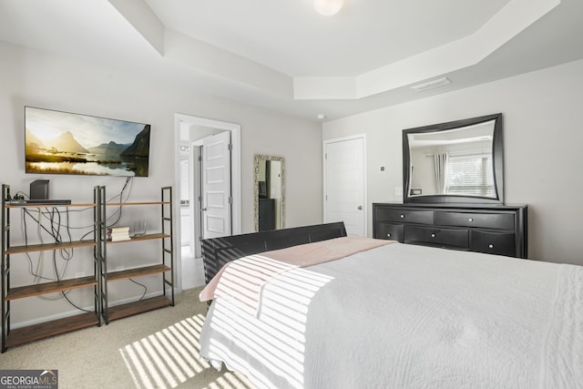 bedroom featuring carpet flooring and a raised ceiling