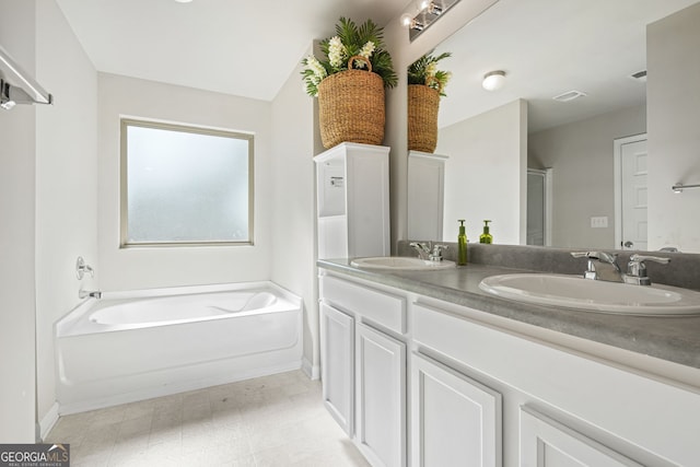 bathroom featuring vanity and a tub