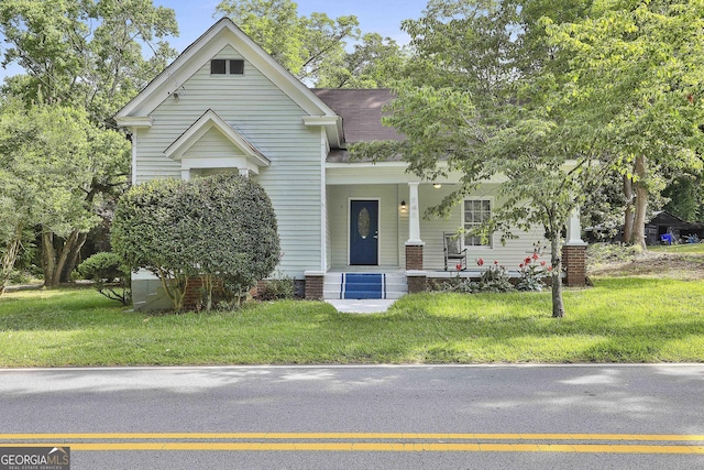 view of front of house with a porch and a front lawn