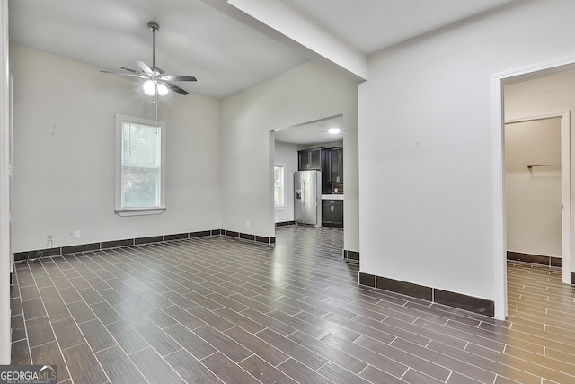 unfurnished living room featuring ceiling fan