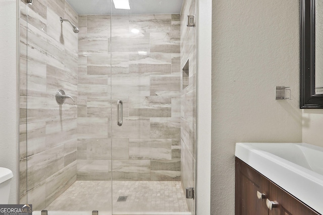 bathroom featuring vanity and a shower with shower door