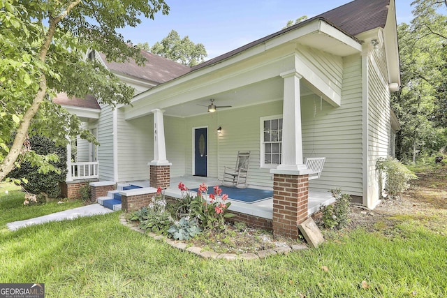 view of front of property with a front lawn, ceiling fan, and covered porch