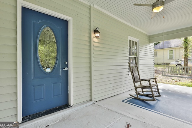 entrance to property with ceiling fan and covered porch