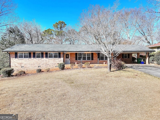 ranch-style house featuring a carport and a front lawn