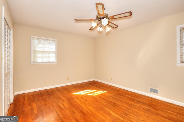 unfurnished bedroom featuring hardwood / wood-style flooring, ceiling fan, and a closet