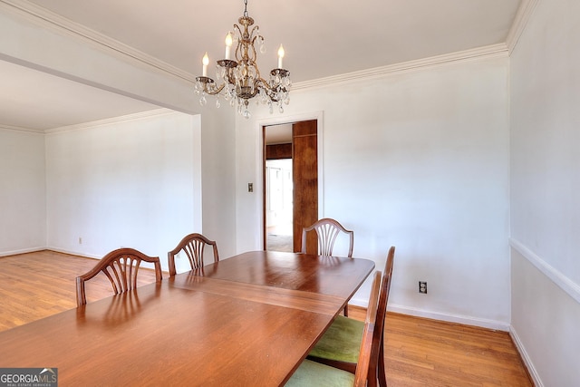 dining space featuring ornamental molding and light hardwood / wood-style floors