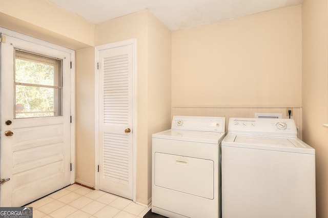 laundry area featuring washer and dryer and light tile patterned floors