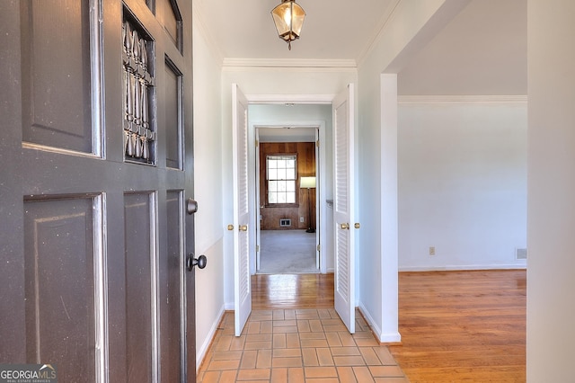 hallway featuring crown molding and light wood-type flooring