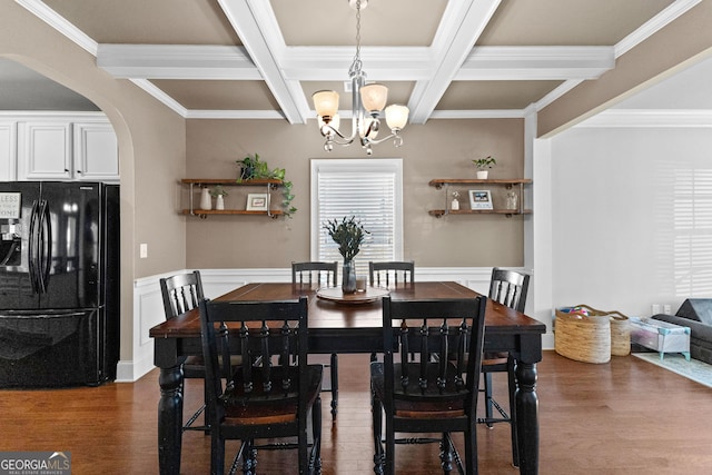 dining room featuring arched walkways, wainscoting, beam ceiling, and a notable chandelier