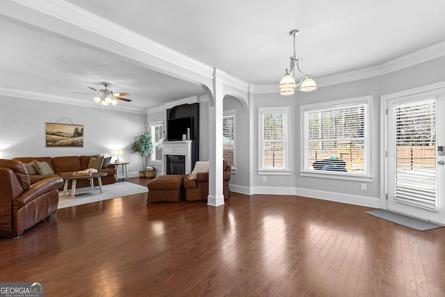 living area with plenty of natural light and dark wood finished floors