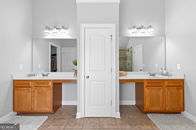 full bathroom with a closet, two vanities, a shower stall, and tile patterned floors