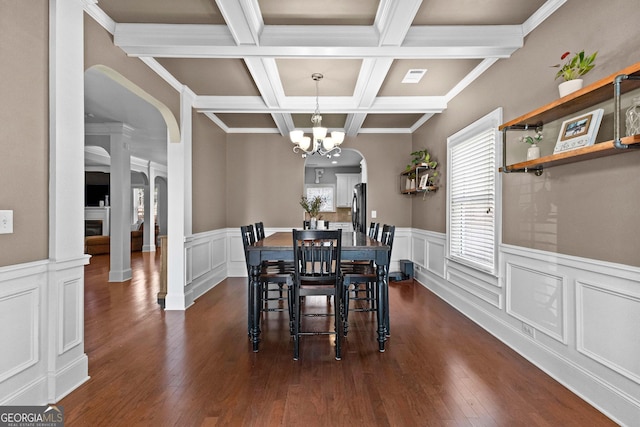 dining area featuring visible vents, dark wood-style flooring, a fireplace, and beam ceiling