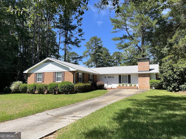 ranch-style home with a front lawn