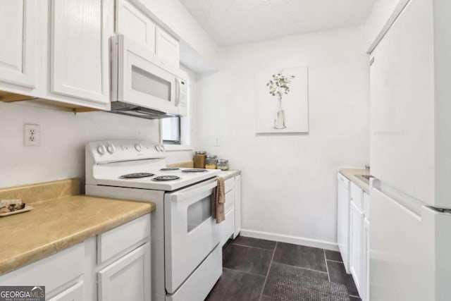 kitchen with white appliances and white cabinets