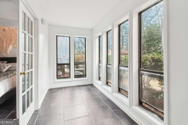 unfurnished sunroom with french doors