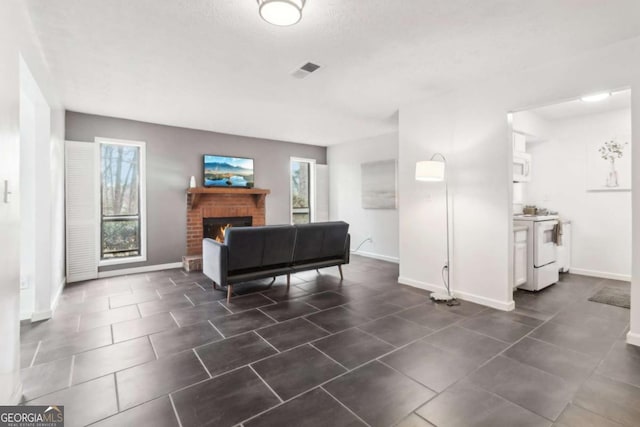 tiled living room with a brick fireplace