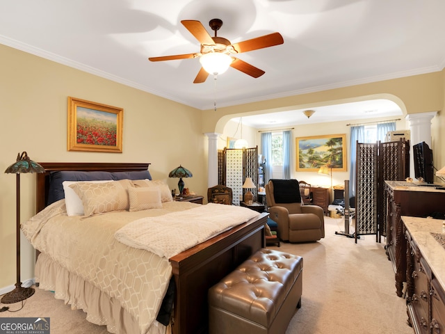 carpeted bedroom with ceiling fan, ornamental molding, and decorative columns