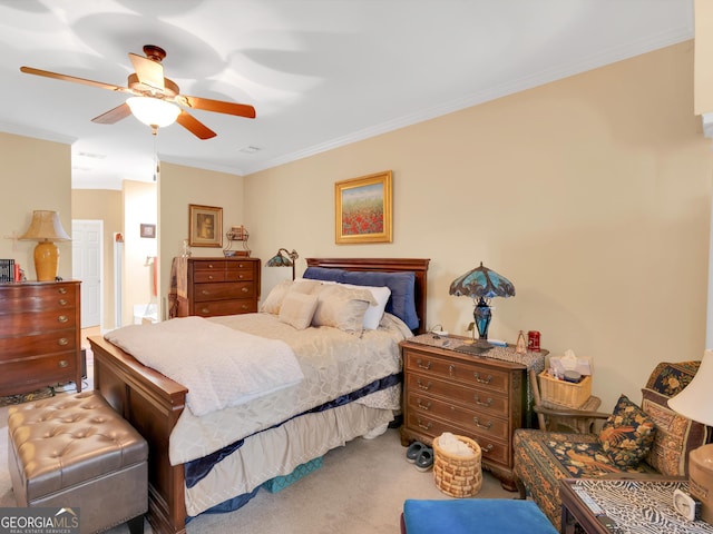 carpeted bedroom featuring ornamental molding and ceiling fan