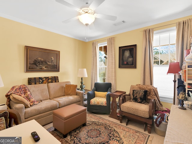 living room with ceiling fan and ornamental molding