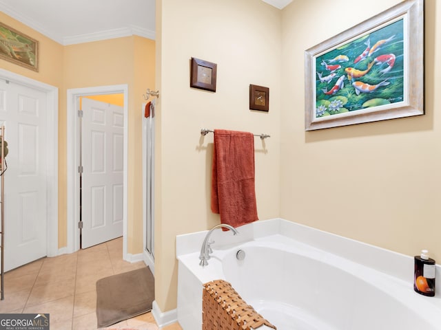 bathroom featuring tile patterned flooring, a bath, and crown molding