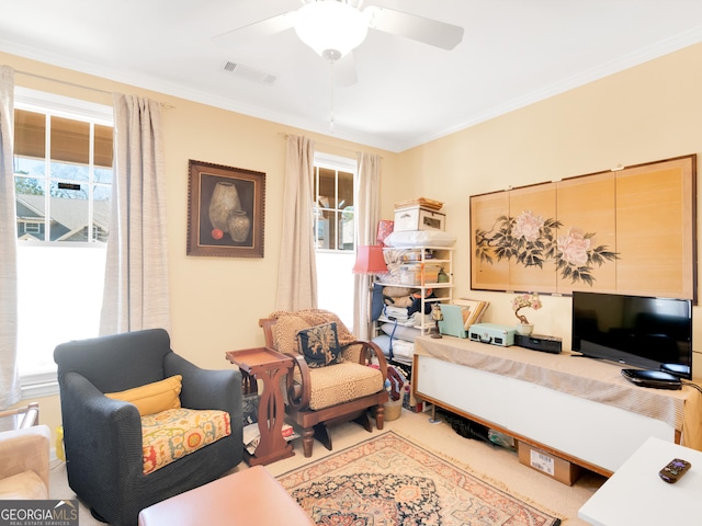 living room with crown molding and ceiling fan