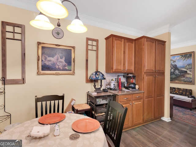 dining room featuring crown molding and dark hardwood / wood-style floors