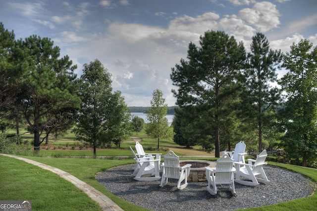 exterior space with a water view and a fire pit