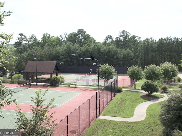 view of sport court with a yard