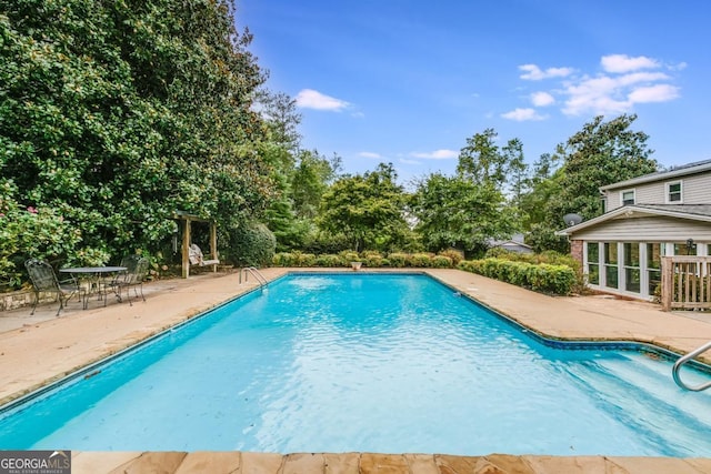 view of swimming pool with a patio area