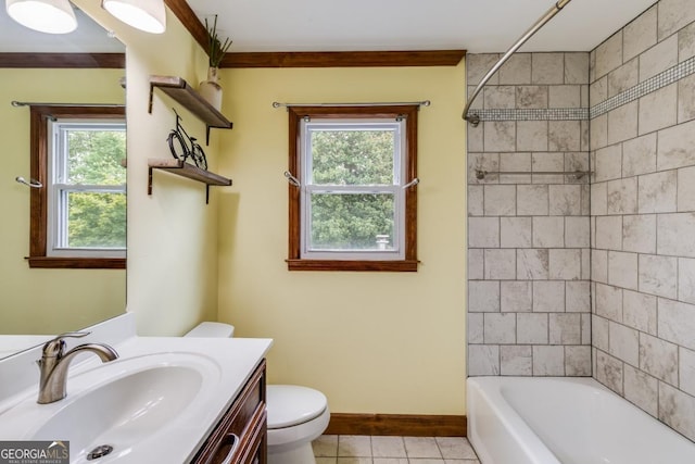 full bathroom featuring vanity, tiled shower / bath, tile patterned flooring, and toilet