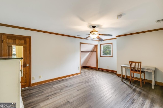 empty room featuring dark wood-type flooring, ceiling fan, and ornamental molding